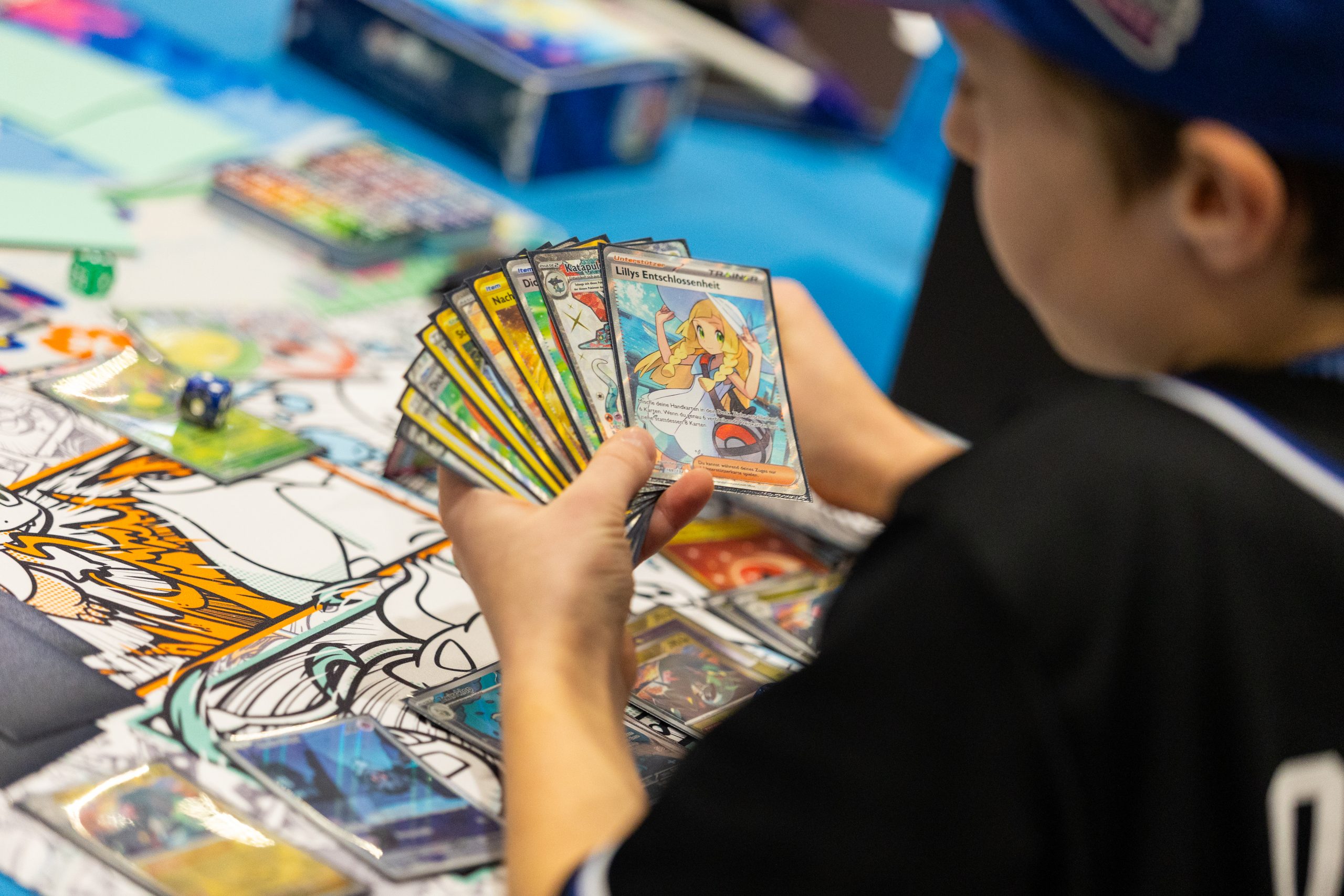Child playing with Pokémon cards